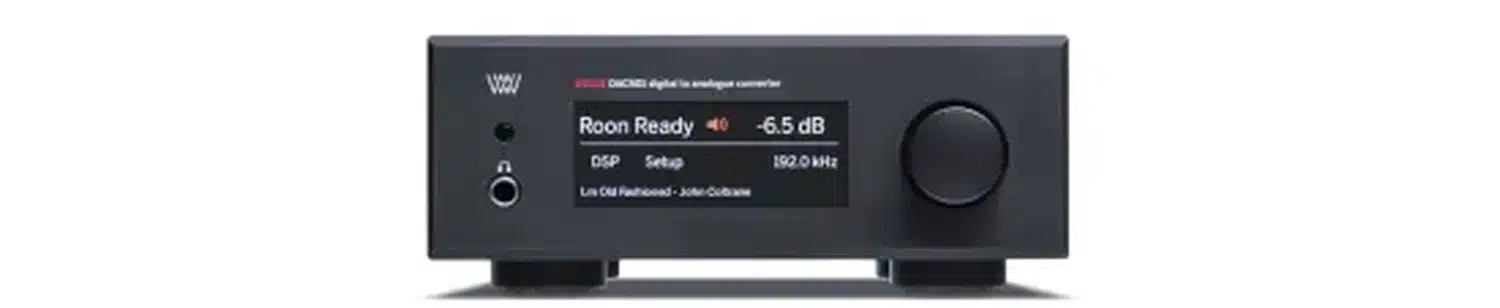 Convertisseur audio numérique Weiss DAC501 noir, affichant notamment la fréquence d'échantillonnage "192kHz", le volume "-6,5dB" et la source "Roon Ready" sur son écran, placé sur un fond blanc. (par 1877.audio)