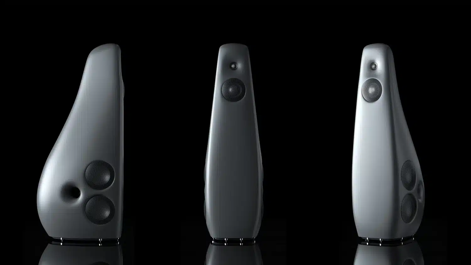 Trois vues différentes, de face, de côté et de trois-quarts, de l'enceinte Vivid Audio Kaya 90 grise sur une surface réfléchissante sur un fond sombre (par 1877.audio)